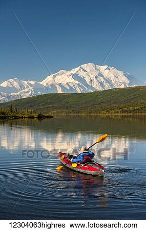 A man kayaking on Wonder Lake in Denali National Park with Denali in the background, Interior Alaska, summer View Large Photo Image Stock Photograph - A man kayaking on Wonder Lake in Denali National Park with Denali in the background, Interior Alaska, summer. Fotosearch