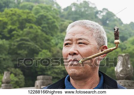 A man smoking in Leshan Giant Buddha scenic area; Sichuan Province, China View Large Photo Image Stock Photograph - A man smoking in Leshan Giant Buddha scenic area; Sichuan Province, China. Fotosearch