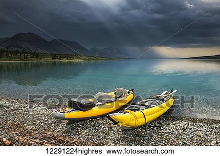 A pair of yellow inflatable kayaks on the Lower Twin Lake beach with a summer thunderstorm in the background, Lake Clark National Park & Preserve, Southcentral Alaska. View Large Photo Image Stock Photograph - A pair of yellow inflatable kayaks on the Lower Twin Lake beach with a summer thunderstorm in the background, Lake Clark National Park & Preserve, Southcentral Alaska.. Fotosearch