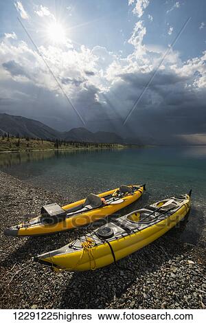 A pair of yellow inflatable kayaks on the Lower Twin Lakes beach with a summer thunderstorm in the background, Lake Clark National Park & Preserve, Southcentral Alaska View Large Photo Image Stock Photograph - A pair of yellow inflatable kayaks on the Lower Twin Lakes beach with a summer thunderstorm in the background, Lake Clark National Park & Preserve, Southcentral Alaska. Fotosearch