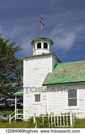 Stock Photograph - A Russian Orthodox church with a weathered green roof, Sand Point, Popof Island, Southwestern Alaska, USA, Summer. Fotosearch