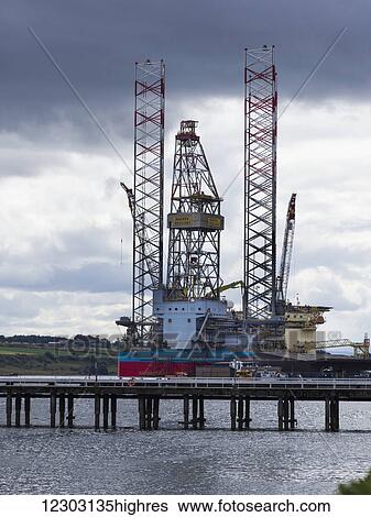 Stock Photograph - A ship at a loading dock at a port; Invergordon, Scotland. Fotosearch
