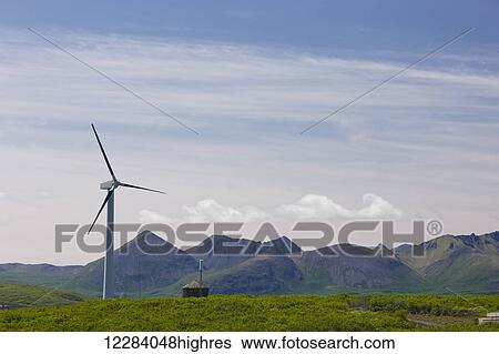 Stock Photograph - A single wind turbine stands on a grassy hill, Sand Point, Southwestern Alaska, USA, Summer. Fotosearch