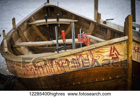 Stock Photograph - A small fishing boat being repaired; Stockholm, Sweden. Fotosearch