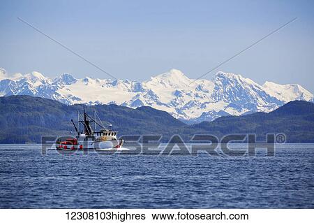 A small fishing boat on the waters of Main Bay, with the Chugach Mountains in the background, Prince William Sound, Whittier, Southcentral Alaska, USA View Large Photo Image Stock Photograph - A small fishing boat on the waters of Main Bay, with the Chugach Mountains in the background, Prince William Sound, Whittier, Southcentral Alaska, USA. Fotosearch