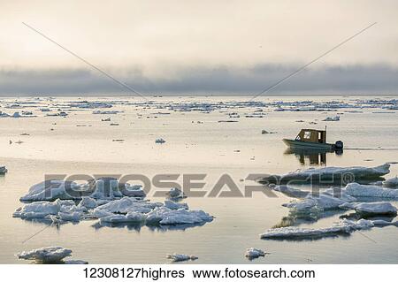 A small outboard boat motors through icebergs in the Arctic Ocean on a calm evening, 0rth Slope, Barrow, Arctic Alaska, USA, Summer View Large Photo Image Stock Photograph - A small outboard boat motors through icebergs in the Arctic Ocean on a calm evening, 0rth Slope, Barrow, Arctic Alaska, USA, Summer. Fotosearch