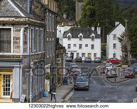 Stock Photograph - A street lined with parked cars in an urban area; Dunkeld, Perth and Kinross, Scotland. Fotosearch