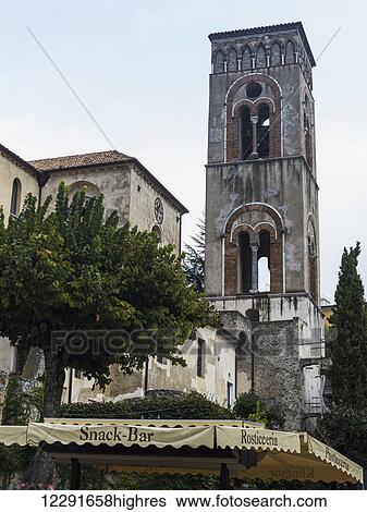A tower against a blue sky with cloud and an awning for a snack bar down below; Ravello, Italy View Large Photo Image Stock Photograph - A tower against a blue sky with cloud and an awning for a snack bar down below; Ravello, Italy. Fotosearch