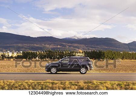 A vehicle driving East on the road from Surrey to Chilliwack; British Columbia, Canada View Large Photo Image Stock Photograph - A vehicle driving East on the road from Surrey to Chilliwack; British Columbia, Canada. Fotosearch