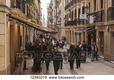 Stock Photo - A view down Calle Major towards the cathedral with crowds of people strolling around; San Sebastian, Spain. Fotosearch