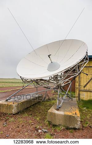 Stock Photo - A white satellite dish sits on two concrete blocks, St. Paul Island, Southwestern Alaska, USA, Summer. Fotosearch