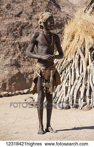A young man in traditional Damara People clothes is posing at The Living Museum of the Damara; Namibia View Large Photo Image Stock Photograph - A young man in traditional Damara People clothes is posing at The Living Museum of the Damara; Namibia. Fotosearch