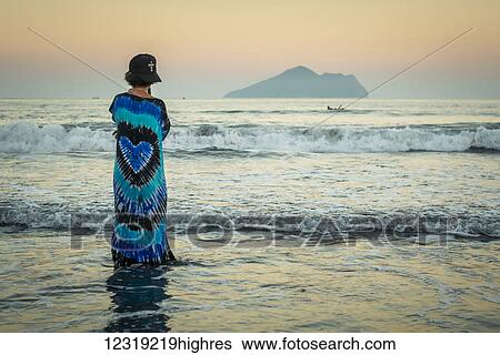 A young woman looking out to the horizon, Waiao beach in Yilan Country, beautiful volcanic beach; Taiwan, China View Large Photo Image Stock Photograph - A young woman looking out to the horizon, Waiao beach in Yilan Country, beautiful volcanic beach; Taiwan, China. Fotosearch