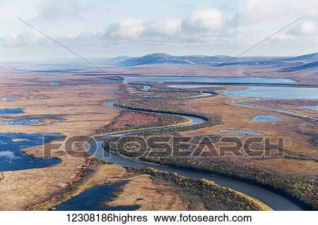 Stock Photograph - Aerial of a winding stream through the tundra during autumn, Arctic Alaska, USA. Fotosearch