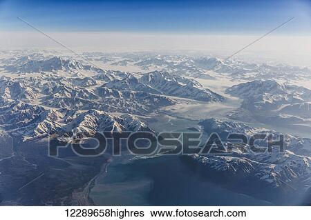 Aerial of snow covered mountains and glaciers along a fjord in the Coastal Range, Southeast Alaska, USA, Summer View Large Photo Image Stock Photograph - Aerial of snow covered mountains and glaciers along a fjord in the Coastal Range, Southeast Alaska, USA, Summer. Fotosearch
