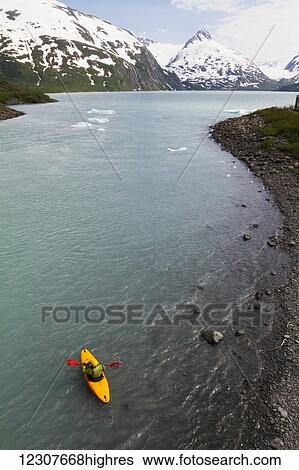 Aerial view of a kayaker at the edge of Portage Lake, Chugach Mountains, Southcentral Alaska, USA View Large Photo Image Stock Photograph - Aerial view of a kayaker at the edge of Portage Lake, Chugach Mountains, Southcentral Alaska, USA. Fotosearch
