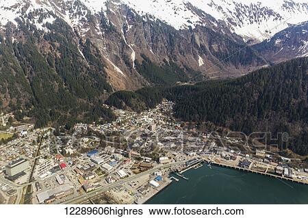 Stock Photograph - Aerial view of downtown Juneau with snowcapped peaks in the background, Juneau, Southeast Alaska, USA, Spring. Fotosearch
