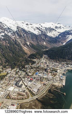 Stock Photograph - Aerial view of downtown Juneau with snowcapped peaks in the background, Juneau, Southeast Alaska, USA, Spring. Fotosearch