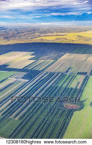 Stock Photograph - Aerial view of farm land in the Matanuska-Susitna Valley near Point MacKenzie, Wasilla, Southcentral Alaska, USA. Fotosearch