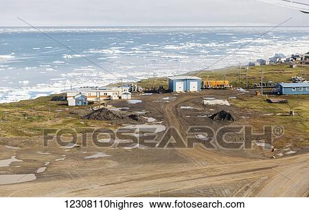 Stock Photograph - Aerial view of roads and coastal housing in Barrow, Sea Ice floating on the Arctic Ocean in the Background, Barrow, Arctic Alaska, USA, Summer. Fotosearch