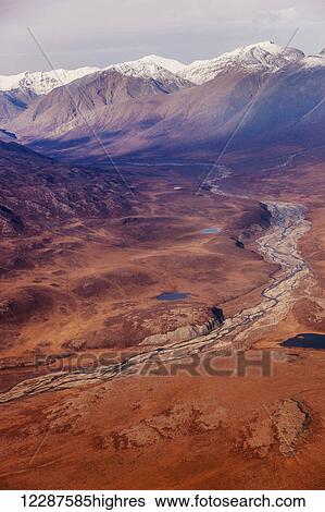 Stock Photograph - Aerial view of small lakes on the floor of a red valley in the Brooks Range, Arctic Alaska, USA, Summer. Fotosearch