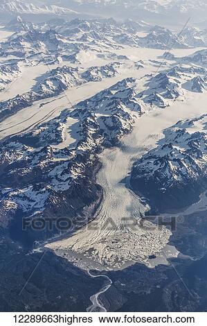 Stock Photograph - Aerial view of snow covered mountains and glaciers in the Coastal Range, Southeast Alaska, USA, Summer. Fotosearch