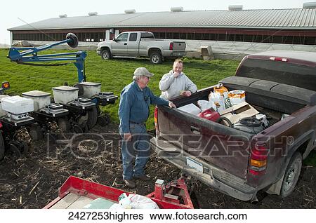 Agriculture -Father and son farmers preparing for spring planting of grain corn / near Northrop, Minnesota, USA. View Large Photo Image Stock Photograph - Agriculture -Father and son farmers preparing for spring planting of grain corn / near Northrop, Minnesota, USA.. Fotosearch