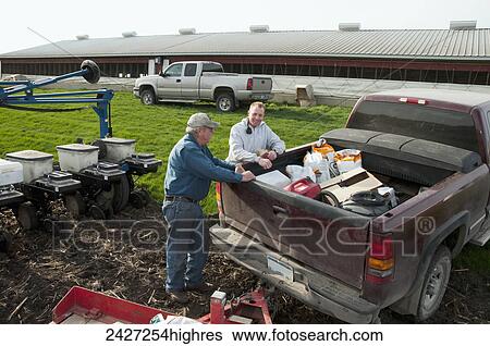 Agriculture -Father and son farmers preparing for spring planting of grain corn / near Northrop, Minnesota, USA. View Large Photo Image Stock Photograph - Agriculture -Father and son farmers preparing for spring planting of grain corn / near Northrop, Minnesota, USA.. Fotosearch