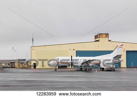 Stock Photo - Airport on St. Paul, A turbo propeller airplane in the foreground, St. Paul Island, Southwestern Alaska, USA, Summer. Fotosearch