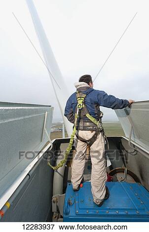 Alaska native technican checking for blade damage atop a wind turbine, St. Paul Island, Southwestern Alaska, USA, Summer View Large Photo Image Stock Photo - Alaska native technican checking for blade damage atop a wind turbine, St. Paul Island, Southwestern Alaska, USA, Summer. Fotosearch