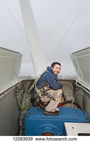 Alaska native technican checking for blade damage atop a wind turbine, St. Paul Island, Southwestern Alaska, USA, Summer View Large Photo Image Stock Photo - Alaska native technican checking for blade damage atop a wind turbine, St. Paul Island, Southwestern Alaska, USA, Summer. Fotosearch