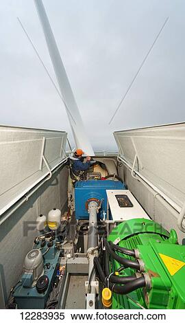 Alaska native technican checking for blade damage atop a wind turbine, St. Paul Island, Southwestern Alaska, USA, Summer View Large Photo Image Stock Photography - Alaska native technican checking for blade damage atop a wind turbine, St. Paul Island, Southwestern Alaska, USA, Summer. Fotosearch