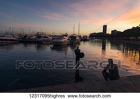 Stock Photograph - Alicantes harbour at sunset; Alicante, Valencia, Spain. Fotosearch