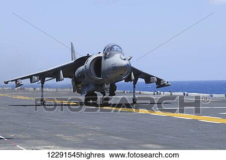 An AV-8B Marine Harrier II lands on the flight deck of the USS Peleliu (LHA-5) during flight operations in the Pacific Ocean; Hawaii, United States of America View Large Photo Image Stock Photograph - An AV-8B Marine Harrier II lands on the flight deck of the USS Peleliu (LHA-5) during flight operations in the Pacific Ocean; Hawaii, United States of America. Fotosearch