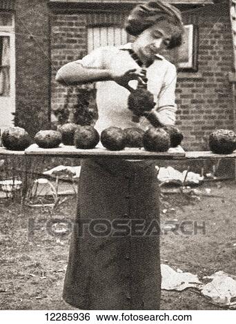 Stock Photograph - An economy measure used during World War One was the mixing of coal-slack with clay to make an efficient substitute for coal. From The Pageant of the Century, published 1934. Fotosearch