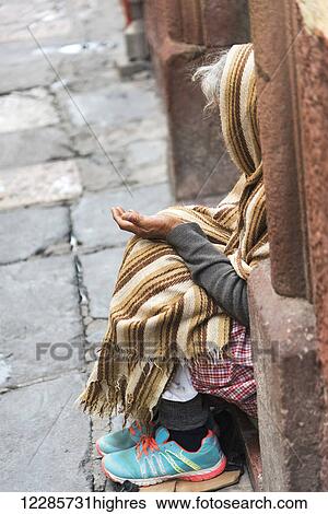 An elderly woman sits on a step with hand open in her lap; San Miguel de Allende, Guanajuato, Mexico View Large Photo Image Stock Photograph - An elderly woman sits on a step with hand open in her lap; San Miguel de Allende, Guanajuato, Mexico. Fotosearch