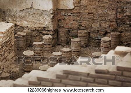 Stock Photograph - Ancient stone walls and seating in a steam room in a museum; Ephesus, Izmir, Turkey. Fotosearch
