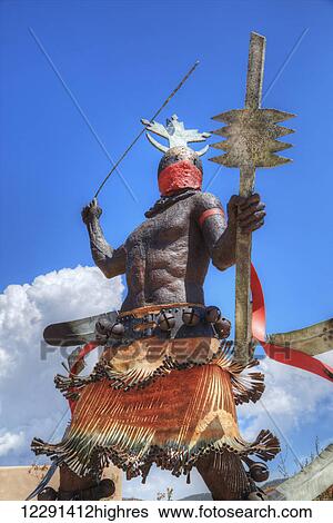 Stock Photograph - Apache Mountain Spirit Dancer Statue, by Craig Dan Goseyun, Museum Hill; Santa Fe, New Mexico, United States of America. Fotosearch