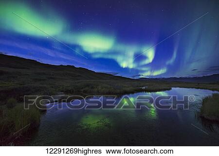 Aurora borealis over a pond in Denali National Park & Preserve, Alaska. View Large Photo Image Stock Photograph - Aurora borealis over a pond in Denali National Park & Preserve, Alaska.. Fotosearch