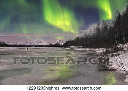 Aurora borealis over frozen Susitna River with Mt. Foraker and Mt. Hunter in the background. View Large Photo Image Stock Photograph - Aurora borealis over frozen Susitna River with Mt. Foraker and Mt. Hunter in the background.. Fotosearch