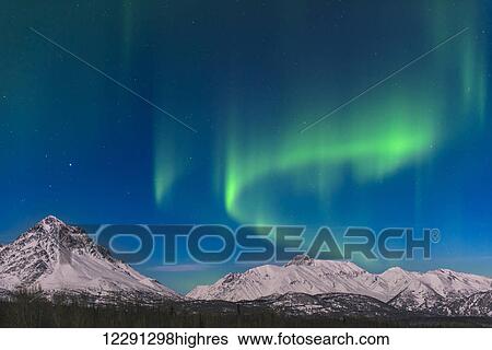 Stock Photograph - Aurora borealis over the Chugach mountains in the Matanuska Valley, Alaska.. Fotosearch