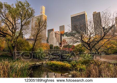 Stock Photograph - Autumn coloured foliage around Gapstow Bridge, Central Park; New York City, New York, United States of America. Fotosearch
