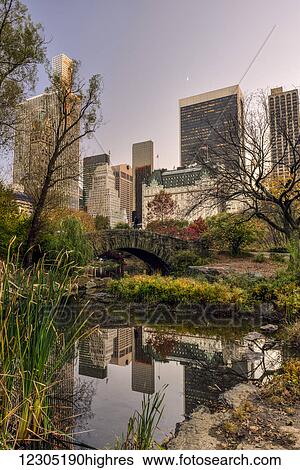 Autumn coloured foliage around Gapstow Bridge, Central Park; New York City, New York, United States of America View Large Photo Image Stock Photograph - Autumn coloured foliage around Gapstow Bridge, Central Park; New York City, New York, United States of America. Fotosearch