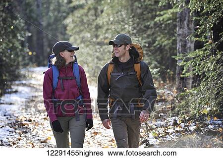 Stock Photograph - Backpacking couple walks the Albert Loop Trail in Chugach State Park near the Eagle River Nature Center in Southcentral Alaska. Fotosearch