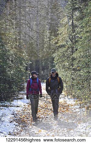 Stock Photograph - Backpacking couple walks the Albert Loop Trail in Chugach State Park near the Eagle River Nature Center in Southcentral Alaska. Fotosearch