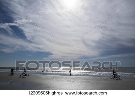 Stock Photograph - Beachgoers enjoy the sand; Hilton Head Island, South Carolina, United States of America. Fotosearch