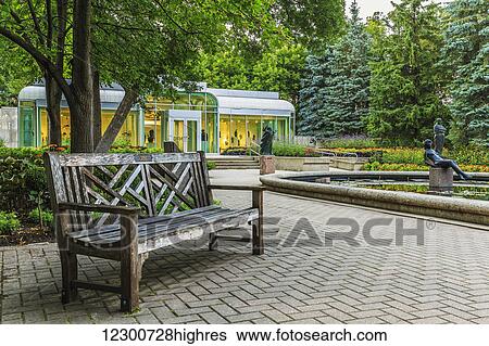 Stock Photograph - Bench in Leo Mol Sculpture Garden of Assiniboine Park; Winnipeg, Manitoba, Canada. Fotosearch