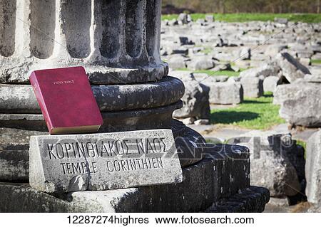Stock Photograph - Bible sitting at temple ruins; Philippi, Greece. Fotosearch
