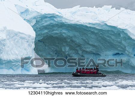 Black inflatable boat going towards iceberg arch; Antarctica View Large Photo Image Stock Photograph - Black inflatable boat going towards iceberg arch; Antarctica. Fotosearch