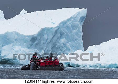 Black inflatable boat motoring past ice cliff; Antarctica View Large Photo Image Stock Photograph - Black inflatable boat motoring past ice cliff; Antarctica. Fotosearch